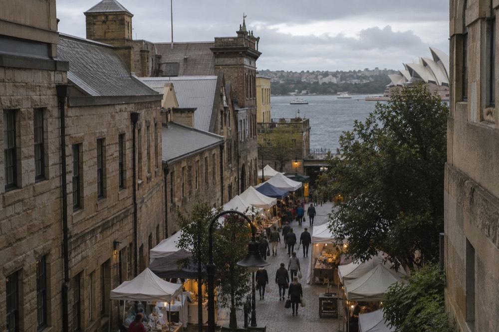 Sandstone laneway in The Rocks with market stalls and historic facades